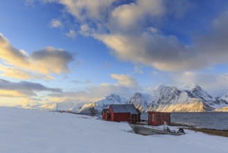 Red boathouses, coast, snowy mountains, fjord, morning light, clouds, snow, Lyngen Alps, Norway,