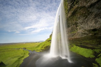 Seljalandsfoss waterfall with rainbow, long exposure, Seljalandsa river, South Iceland, Iceland,