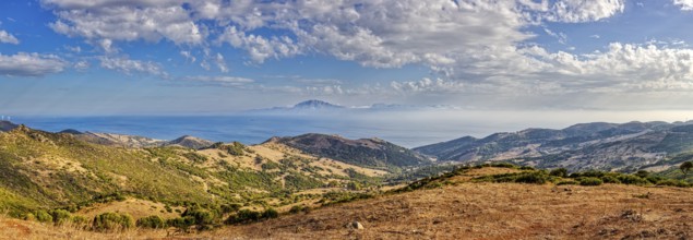 Panorama of a wide hilly landscape with a view of the sea, near Tarifa, view to Morocco