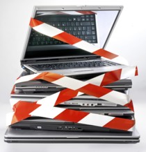 Pile of discarded notebooks, wrapped with barrier tape, disposal issue