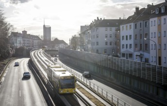 Essen, North Rhine-Westphalia, Germany - Cars and a public bus drive on the A40 motorway through