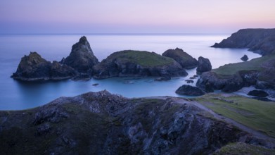 Kynance Cove with Asparagus Island, with sea, sandy beach and rocks in the evening. Coastal