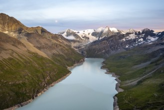 Picturesque mountain landscape at the summit Mont de la Blana at sunset with full moon, view of