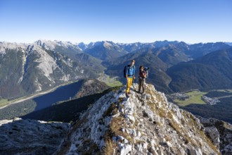Mountaineer at the summit of the Große Arnspitze, mountain panorama with Karwendel mountains,
