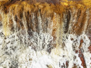 Detail of a waterfall in the Rio Tinto (Red river) with its orange-red hue due to oxidised iron