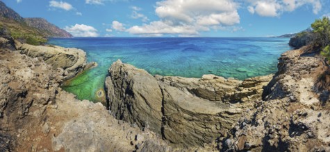 Dramatic rock formations overlooking turquoise waters, hiking trail from Avlona to Diafani, Avlona,