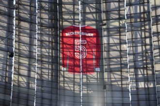 Larger-than-life jersey of Franz Beckenbauer with shirt number 5 hanging in the grandstand roof of