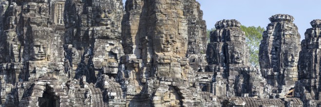 Panoramic image of giant stone-carved faces of the Bodhisattva Lokeshvara, also known as