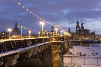 Old town across the Elbe in snow with fairy lights on the Augustus Bridge, Frauenkirche,