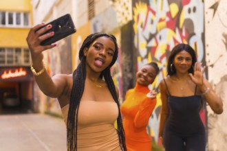 San Sebastián, Gipuzkoa Spain, February 2021: Three girls taking a selfie. Fashionable urban style