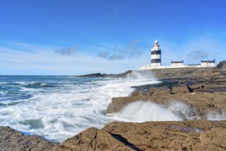 Hook Head lighthouse, blue sky and spray, Wexford, Ireland, Europe