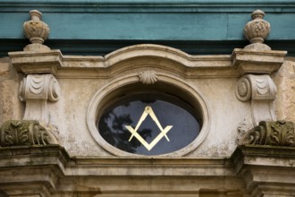 Close-up with compass and angle, two of the best-known symbols of Freemasonry on the lodge house,