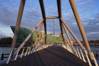 AMSTERDAM, NETHERLANDS, MAY 9, 2017: NEMO Science museum and Mr. J. van der Veldebrug bridge. It is