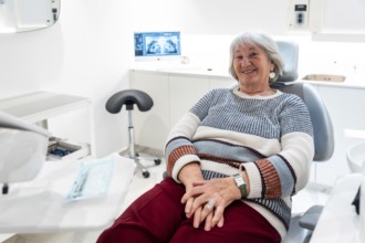 Elderly patient smiling and feeling comfortable during a dental checkup in a bright, modern clinic,