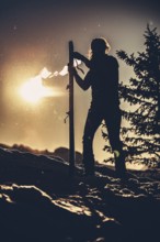 A woman's ski tour at sunrise on the Tegelberg in the Allgäu in the Ammergebirge, Bavaria, Germany,