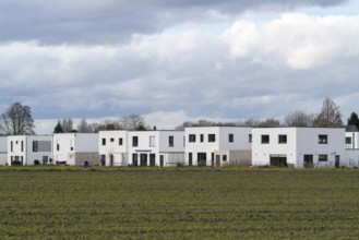 New housing estate, single-family houses with flat roof, clouds in the sky, Kamen, North