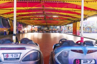 Empty bumper car hall with colourful vehicles, ready for visitors at a carnival, Weil der Stadt,