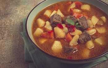 Meat goulash, with potatoes and carrots, sweet pepper, traditional Hungarian soup, homemade, no