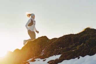 Trail running in autumn on the Jochberg on Lake Walchensee against the wonderful backdrop of the