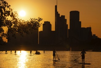 The sun sets behind the Frankfurt banking skyline, Frankfurt am Main, Hesse, Germany, Europe