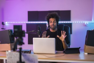 Frontal portrait of a influencer recording a video tutorial in a music studio