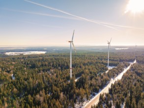 Snow-covered forest with wind turbines under a clear sky, Seewald, Black Forest, Germany, Europe