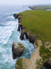 Impressive view of steep cliffs with unique rock formations and a lush green landscape, aerial