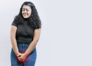 Young woman with urinary problems isolated. Girl with hands on crotch with urinary problems. People