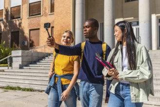 Multi-ethnic university students recording vlog with small portable digital camera
