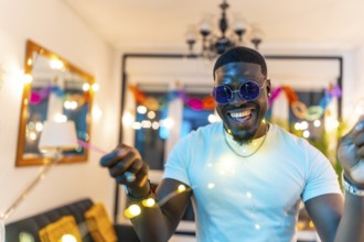 Close-up portrait of a handsome african man laughing dancing in a home night party
