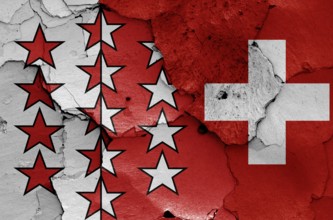 Flags of Valais canton and Switzerland painted on cracked wall