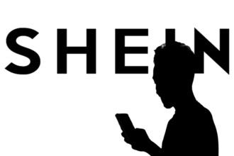 Smartphone with website of fashion e-commerce company Shein in front of business logo. Focus on