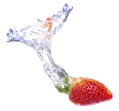 Strawberry dropped on a water tank with a splash of water behind it
