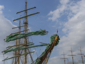 The masts and sails of a large sailing ship against a blue sky with few clouds, bremerhaven,