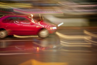 Car moving in rainy night motion blur on light and vehicle