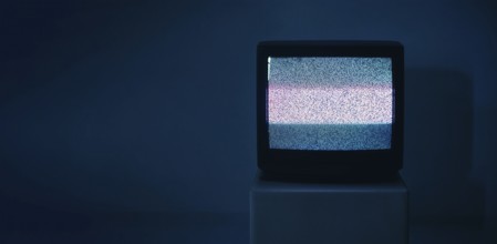 No TV signal on old television with copy space on dark background. Interference, television noise.