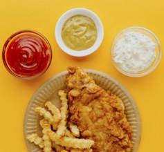 Top view fish chips plate with sauces
