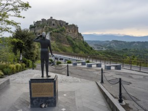 Sculpture with a view of the hilltop village of Civita di Bagnoregio, Lazio, Italy, Europe