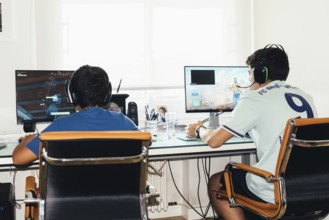 Madrid, Spain, August 23, 2019: Teenagers playing Fortnite video game and CSGO Counter Strike on PC