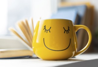 Open book smiley yellow cup