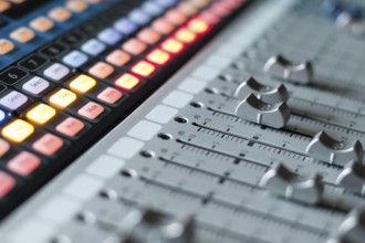 Professional music production in a sound recording studio, mixer desk