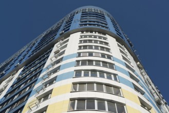 Modern multi-storey residential building on a background of blue sky