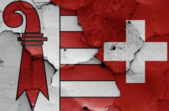 Flags of Jura canton and Switzerland painted on cracked wall