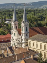 View of church towers and surrounding houses with tiled roofs in a picturesque village, esztergom,