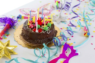 Children birthday party with chocolate cake confetti garland and serpentine