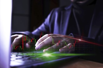 Businessman using computer with stock market virtual increasing stock market graph chart. Business