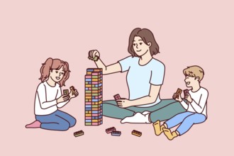 Woman babysitter together with kids plays constructor building tower of children blocks in