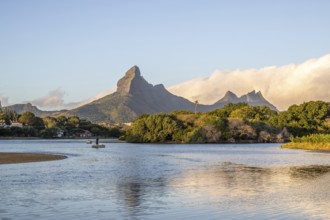 A bay on a river. Dream beach in a pastel-coloured sunset on a holiday island. A gently sloping