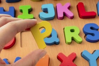 Colorful Letter of Alphabet P made of wood in hand