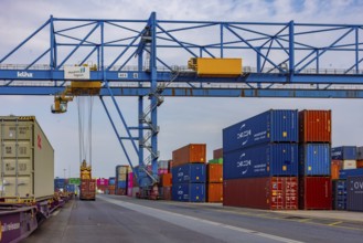 Crane loads containers onto trains and lorries at the D3T container port, Logport l, Rhine,